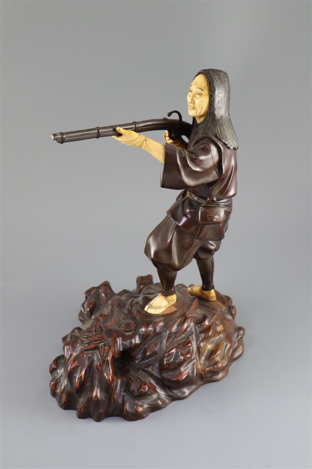 A good Japanese bronze and ivory okimono of a huntsman, Meiji period, 34cm high